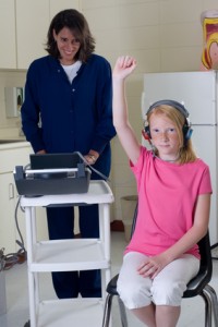 School nurse giving hearing test